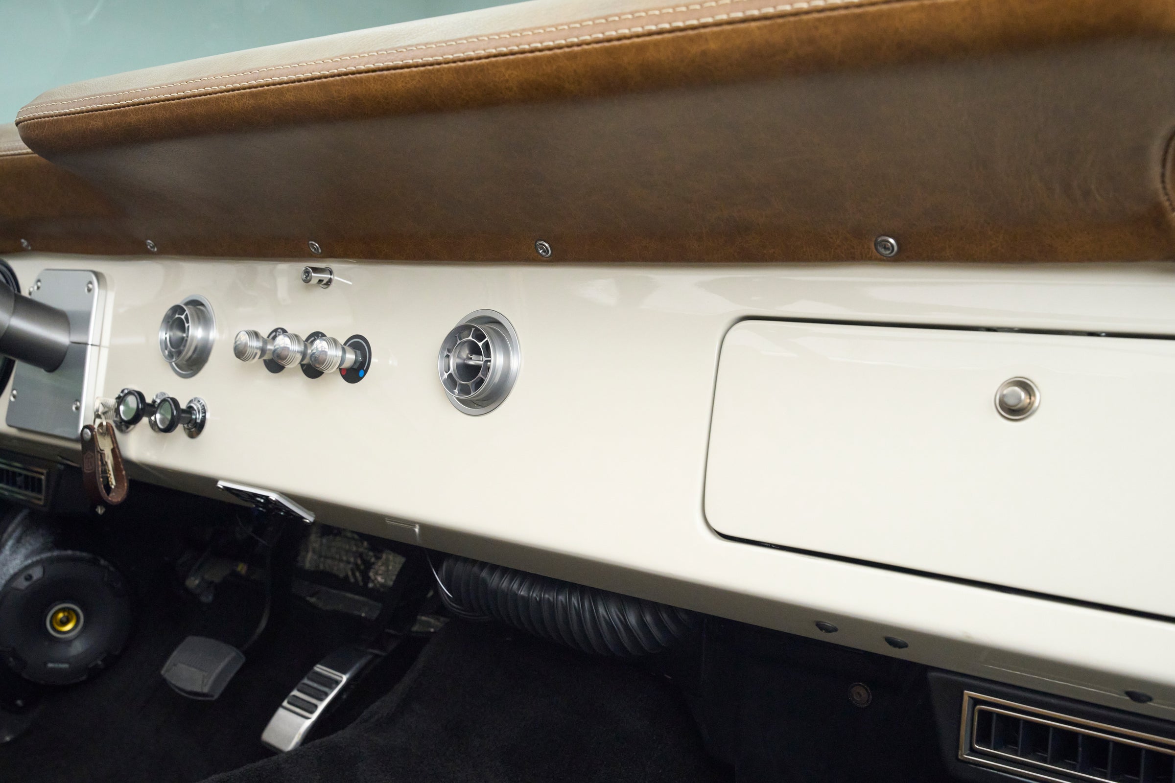 Interior dashboard area of Classic Ford Bronco with knobs, speaker, and air vents