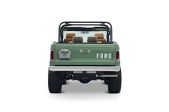 Rear view of green Classic Ford Bronco The Sutton with roll cage and brown leather and plaid headrests
