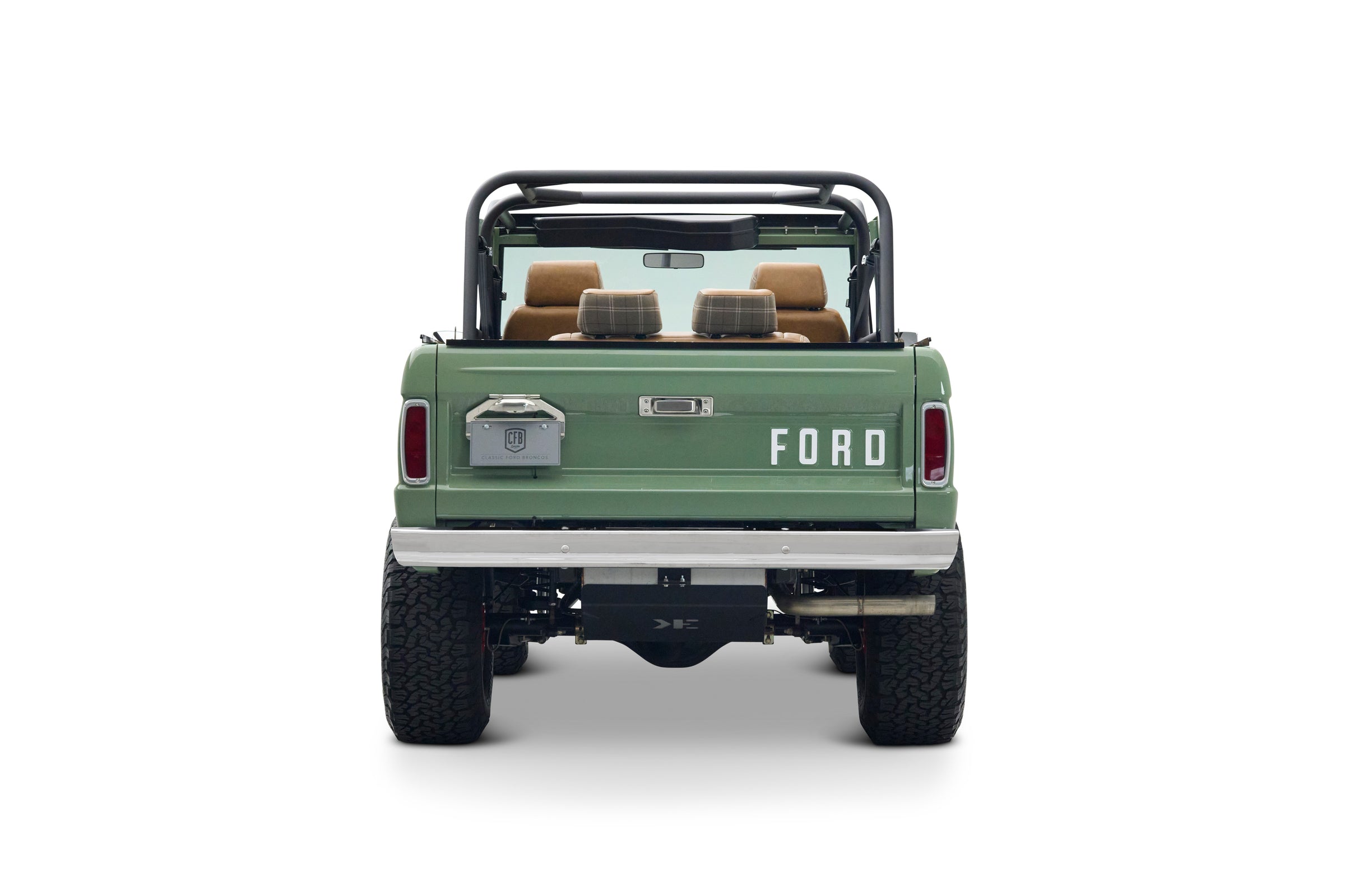 Rear view of green Classic Ford Bronco The Sutton with roll cage and brown leather and plaid headrests
