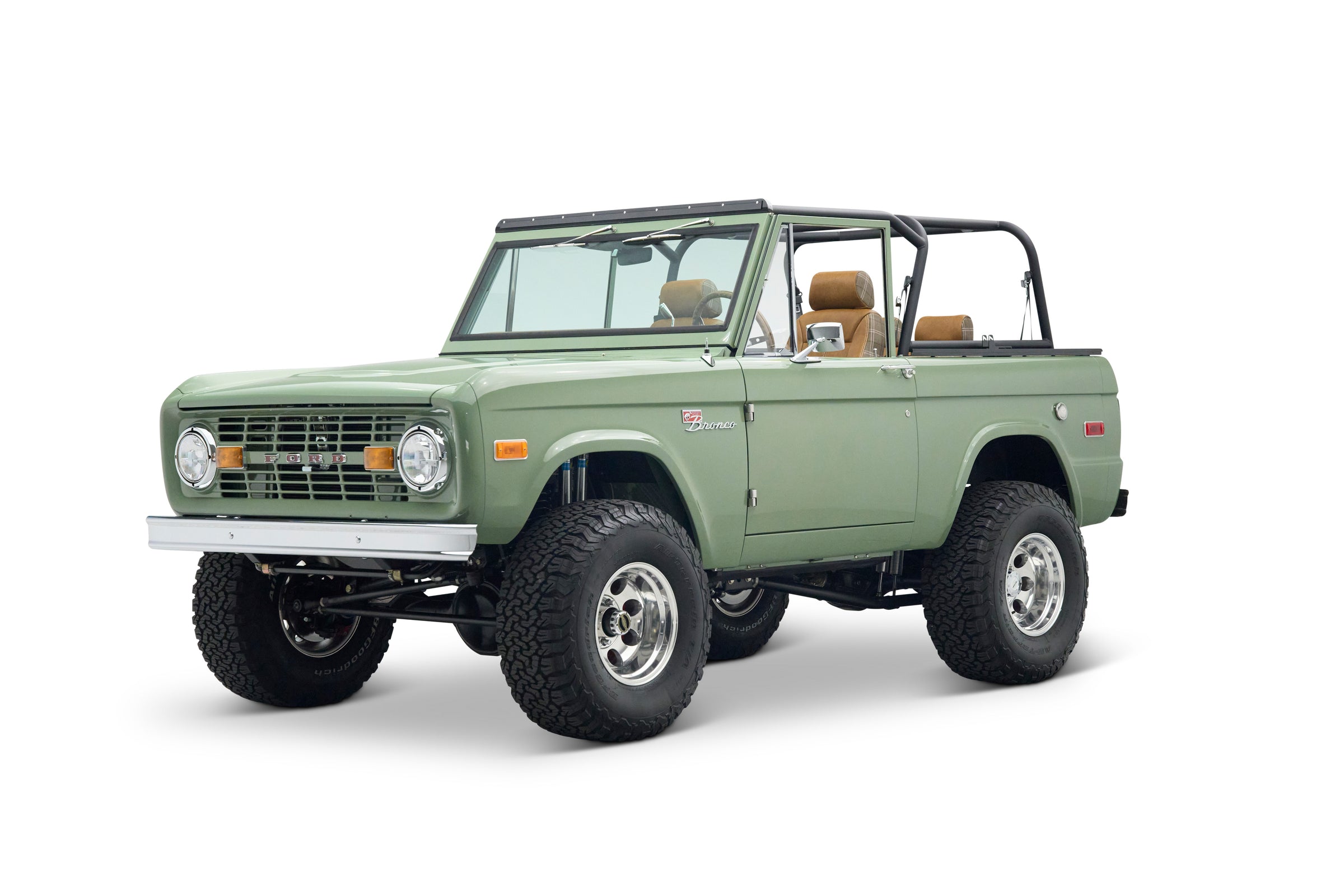 Front three-quarter view of a green Classic Ford Bronco with off-road tires and black roll cage