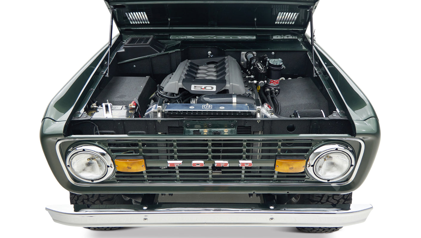 Classic Ford Bronco 1973 Highland Green with open hood showing Coyote 5.0 engine front view