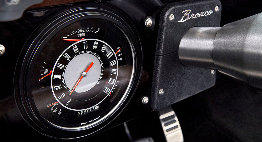 Classic Ford Bronco speedometer and tachometer cluster with black dashboard
