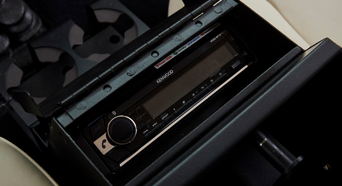 Kenwood car stereo system installed in the console of a Classic Ford Bronco