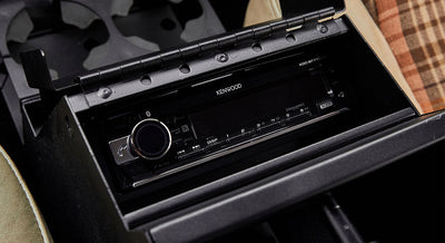 Kenwood stereo installed in a black center console compartment