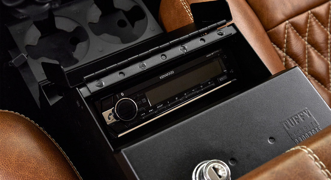 Black lockable Tuffy security box in center console area with Kenwood stereo underneath in Classic Ford Bronco