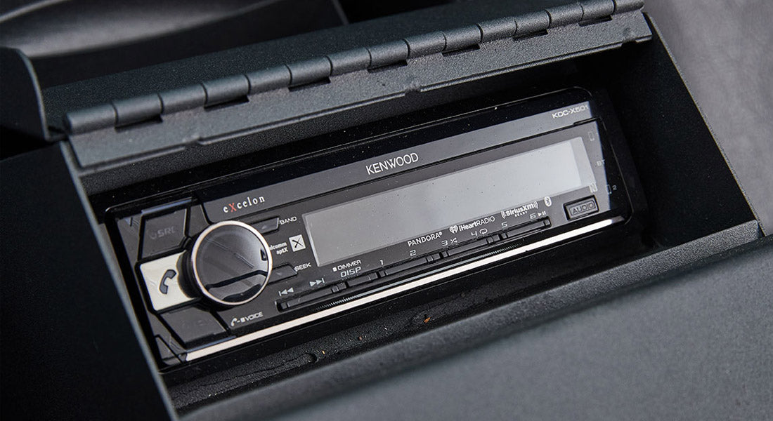 Black console housing a Kenwood car stereo in Classic Ford Bronco