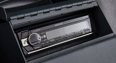Black console housing a Kenwood car stereo in Classic Ford Bronco