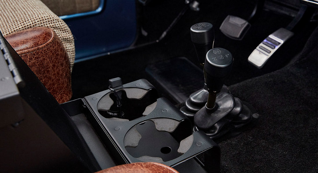Interior console area with cup holders and gear levers in a Classic Ford Bronco