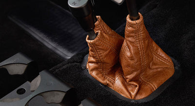Classic Ford Bronco interior center console with dual leather shift boots in brown