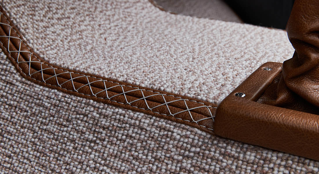Close-up of beige carpet with leather trim inside Classic Ford Bronco
