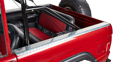 Red Classic Ford Bronco rear side with black and red interior seats and diamond plate trim