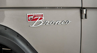 Classic Ford Bronco Sport badge on beige vehicle body near door hinge and black fender flare