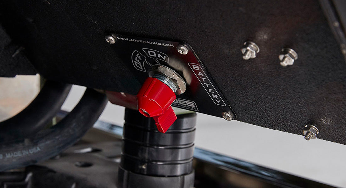 Red battery switch close-up showing off position with mounting screws