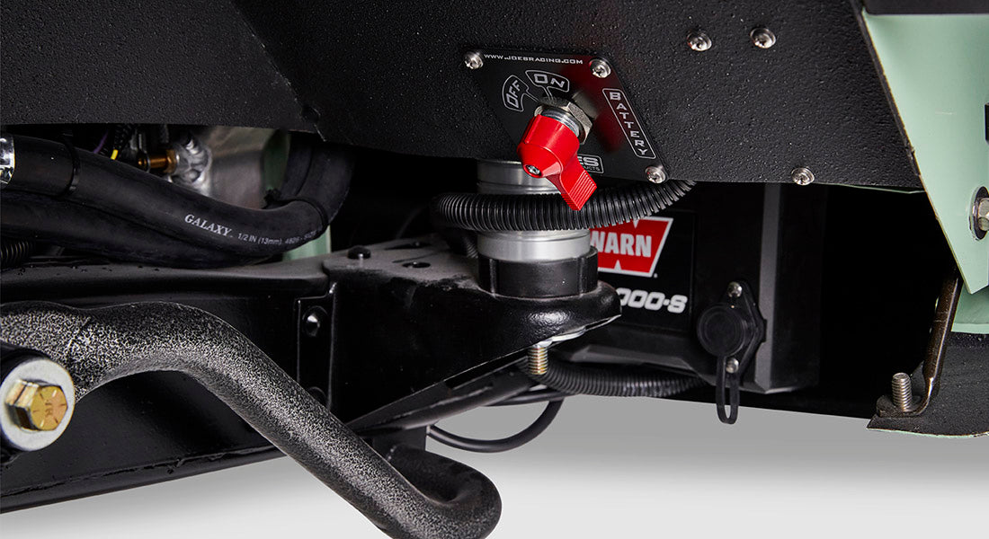 Close-up of battery switch with red lever inside Classic Ford Bronco near Warn winch battery box.
