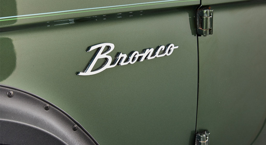 Interior view of Classic Ford Bronco showing two gear shifters with round silver knobs