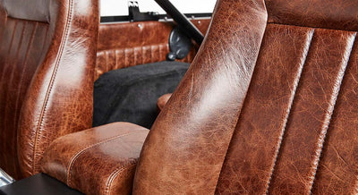 Close-up of brown leather seat upholstery inside a Classic Ford Bronco