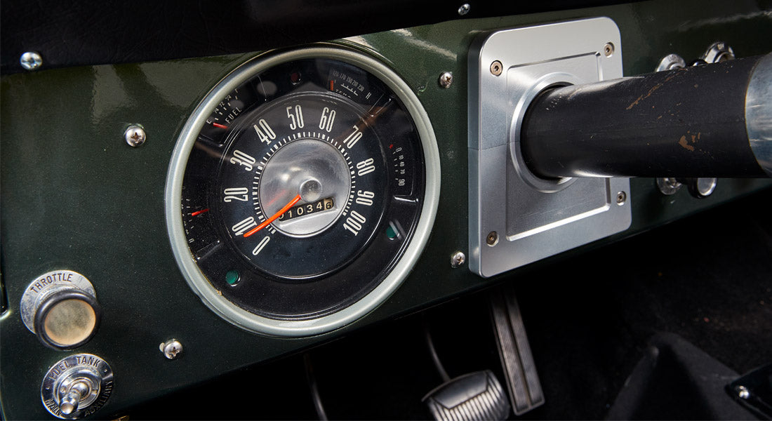 Close-up of Classic Ford Bronco speedometer with fuel gauge and throttle control knob