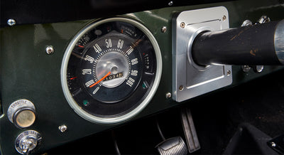 Close-up of Classic Ford Bronco speedometer with fuel gauge and throttle control knob