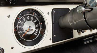 Classic Ford Bronco dashboard speedometer showing fuel, temperature, and mileage details.