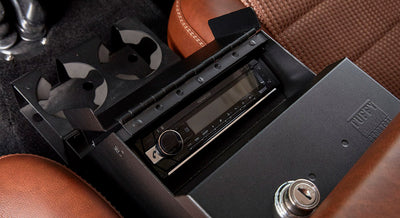 Kenwood car stereo installed in a brown leather interior compartment