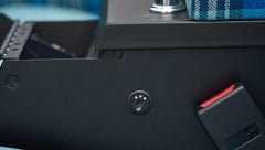 Detail of seat heating control button and red seatbelt buckle in Classic Ford Bronco interior
