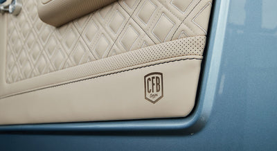 Beige quilted door upholstery with CFB Series branding on the bottom corner in a Classic Ford Bronco