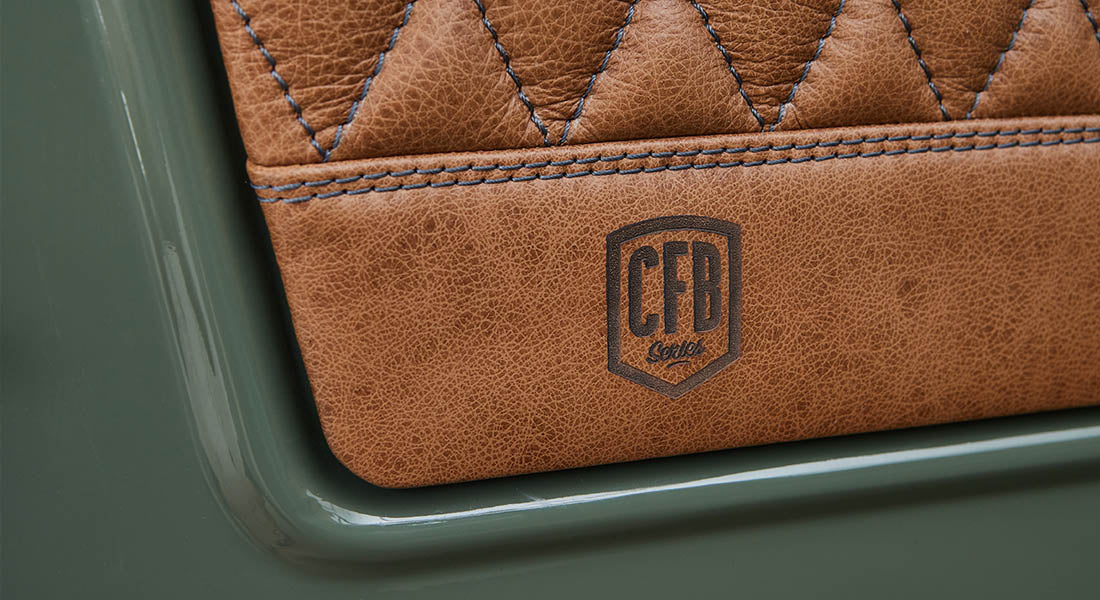 Close-up of diamond-stitched tan leather panel with CFB Series branding on door of Classic Ford Bronco