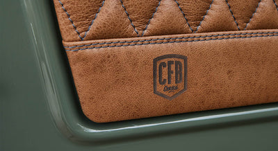 Close-up of diamond-stitched tan leather panel with CFB Series branding on door of Classic Ford Bronco