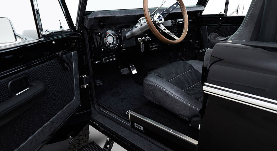 Interior door panel and step entrance of Classic Ford Bronco with black and gray upholstery