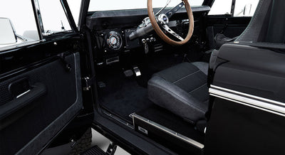 Interior door panel and step entrance of Classic Ford Bronco with black and gray upholstery