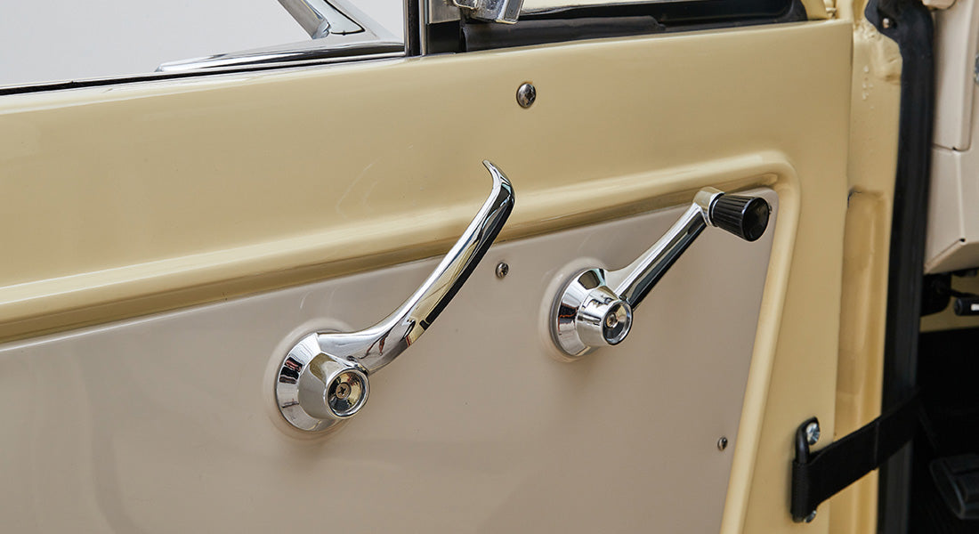 Classic Ford Bronco door interior with beige and cream panel and chrome handles