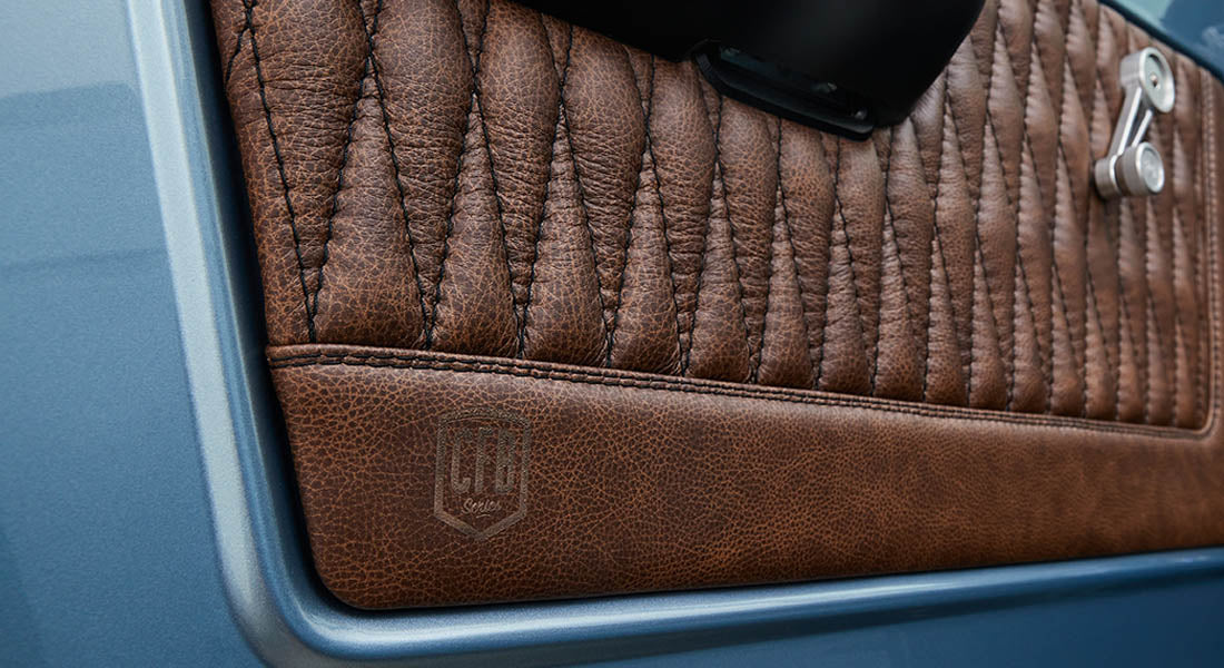 Close-up of brown leather door panel detail with stitching inside Classic Ford Bronco