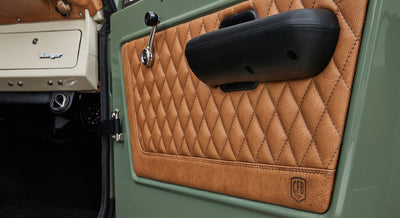 Quilted tan leather door panel with black armrest and Ford Bronco Ranger branding