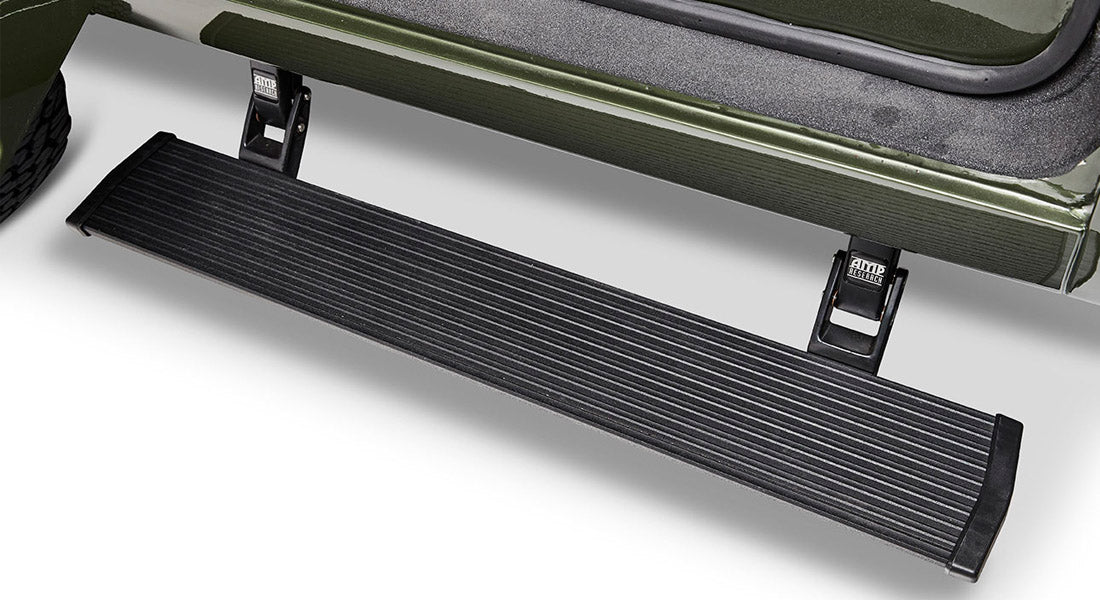 Black metal door step attached to green Classic Ford Bronco