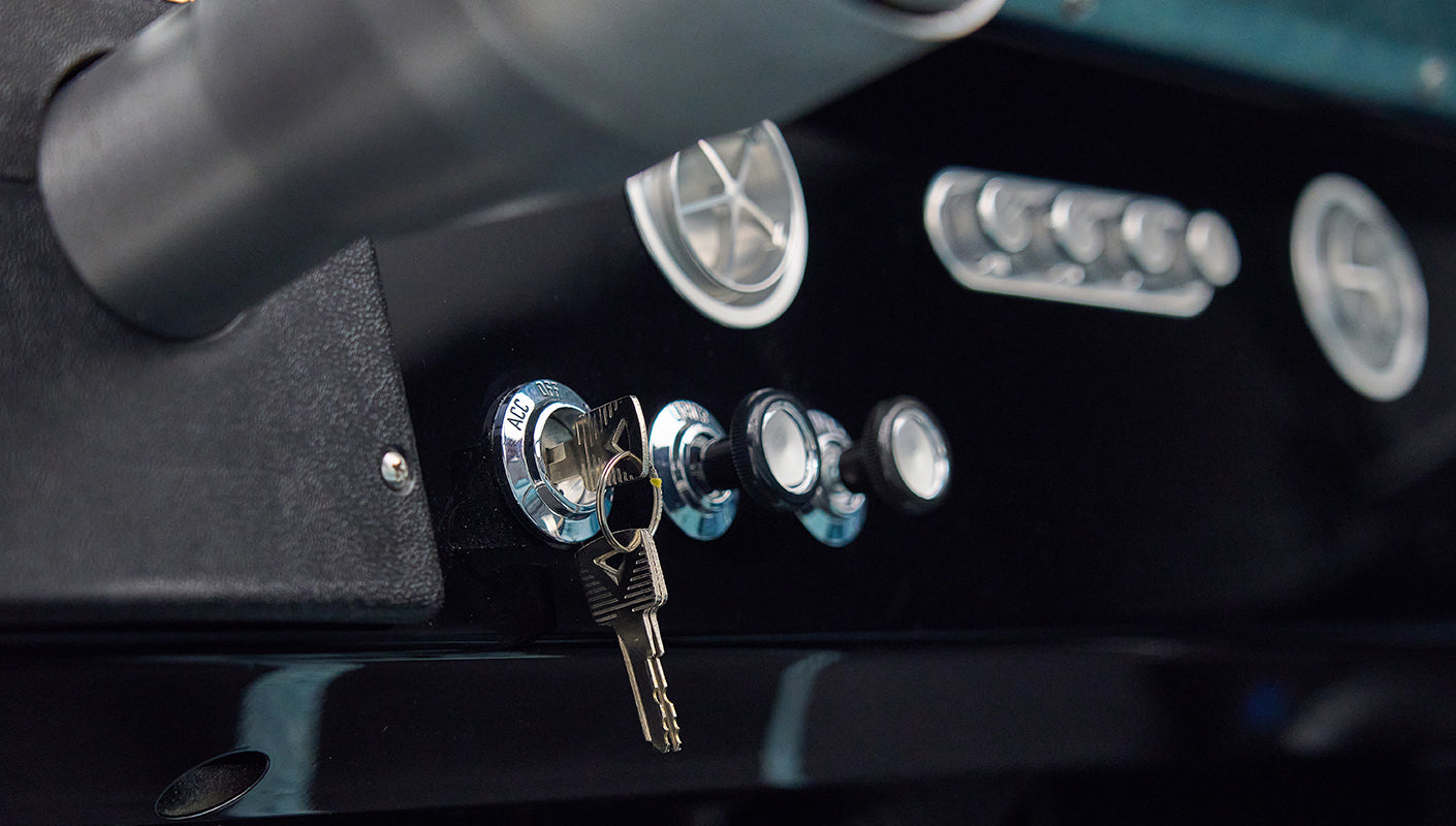 Classic Ford Bronco dashboard with ignition keys and chrome switches