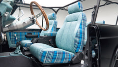 Classic Ford Bronco front seats with blue plaid upholstery and black roll cage