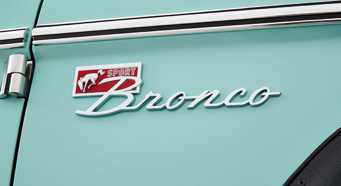 Classic Ford Bronco side emblem with red background and running horse logo