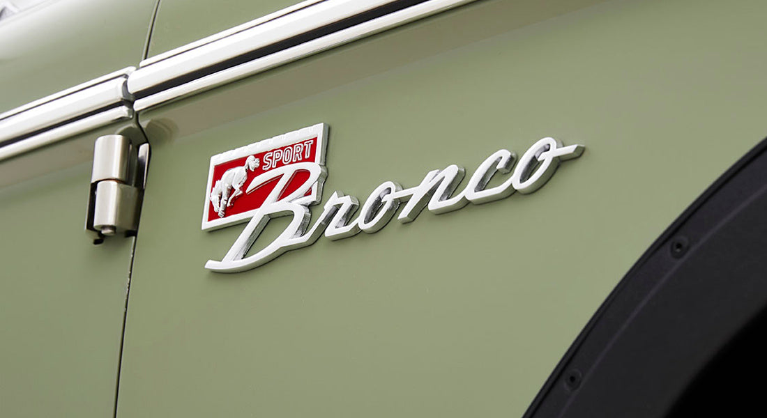 Close-up of Classic Ford Bronco Sport logo emblem on green vehicle door