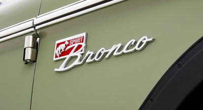Close-up of Classic Ford Bronco Sport logo emblem on green vehicle door