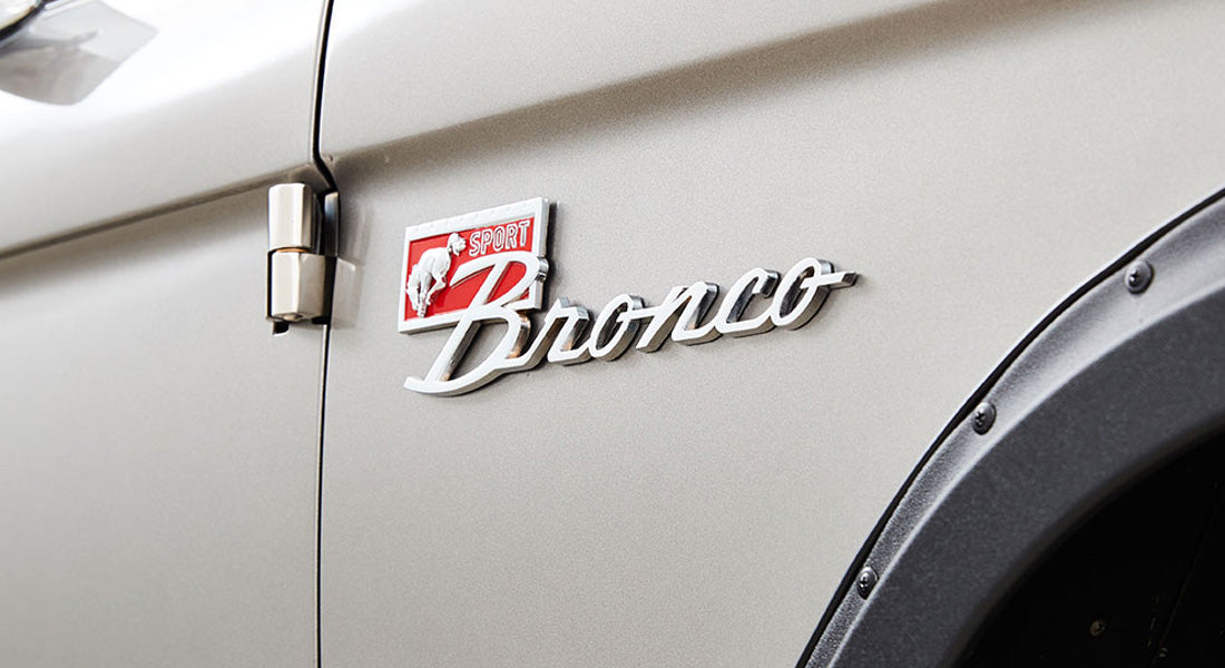 Classic Ford Bronco Sport emblem on the side of the vehicle with cream paint