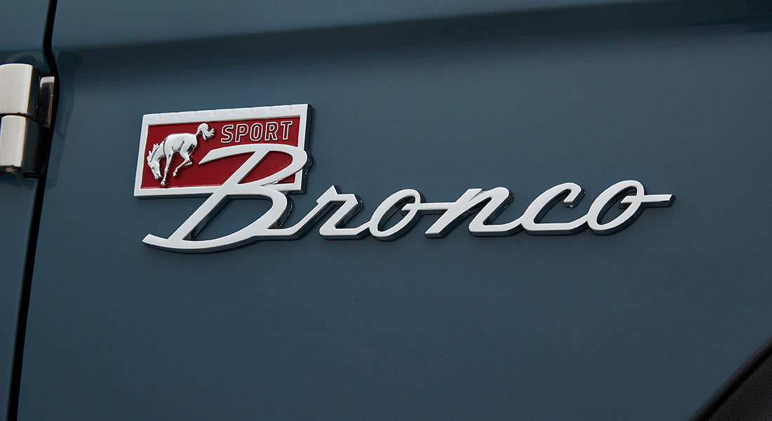 Classic Ford Bronco Sport emblem on blue painted vehicle body