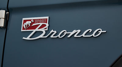 Classic Ford Bronco Sport emblem on blue painted vehicle body