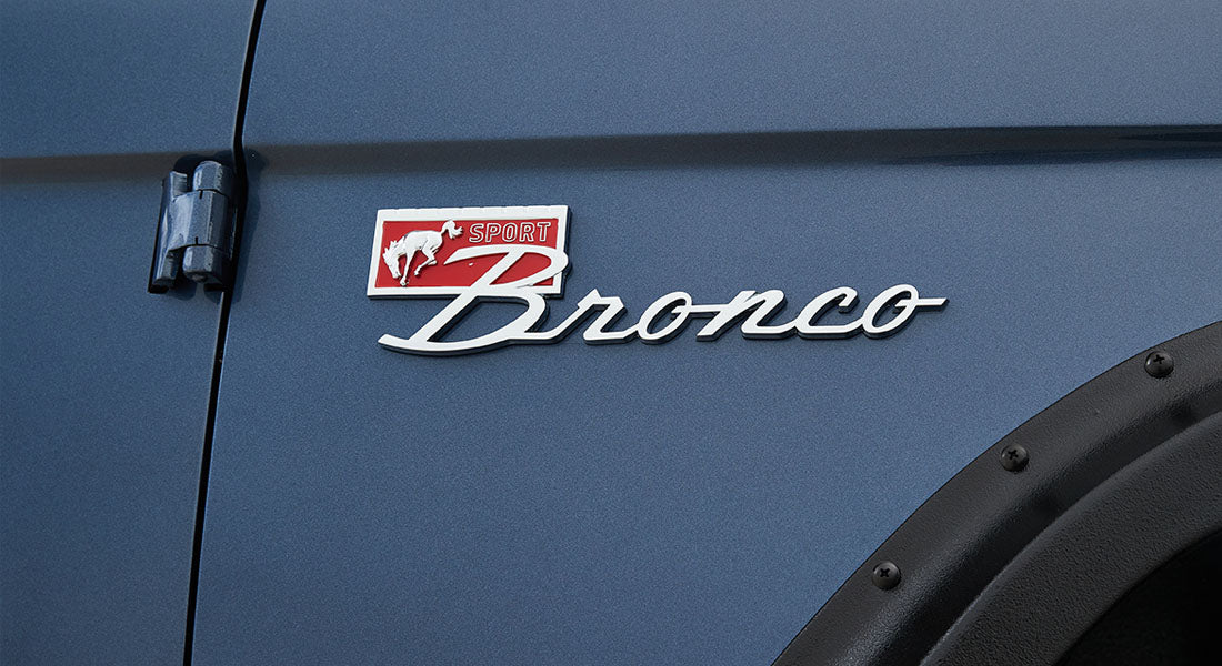 Classic Ford Bronco emblem with red and white colors on blue vehicle body