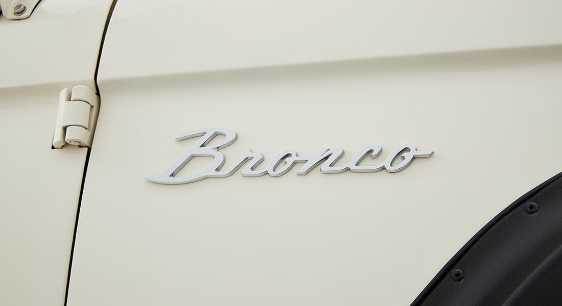 White Classic Ford Bronco side panel with silver Bronco emblem and black fender flare
