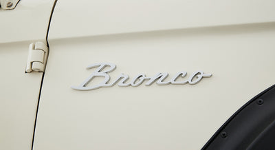 White Classic Ford Bronco side panel with silver Bronco emblem and black fender flare