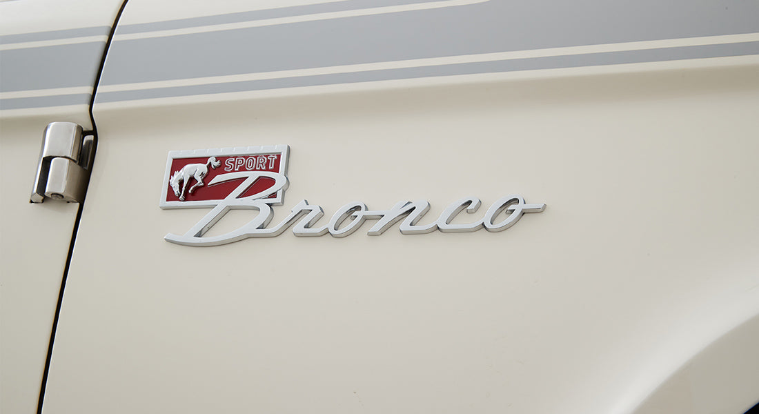 Classic Ford Bronco Sport emblem mounted on cream-colored vehicle door