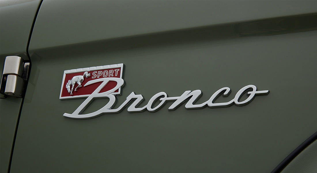 Classic Ford Bronco emblem with Sport badge on green exterior door