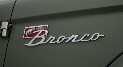 Classic Ford Bronco emblem with Sport badge on green exterior door
