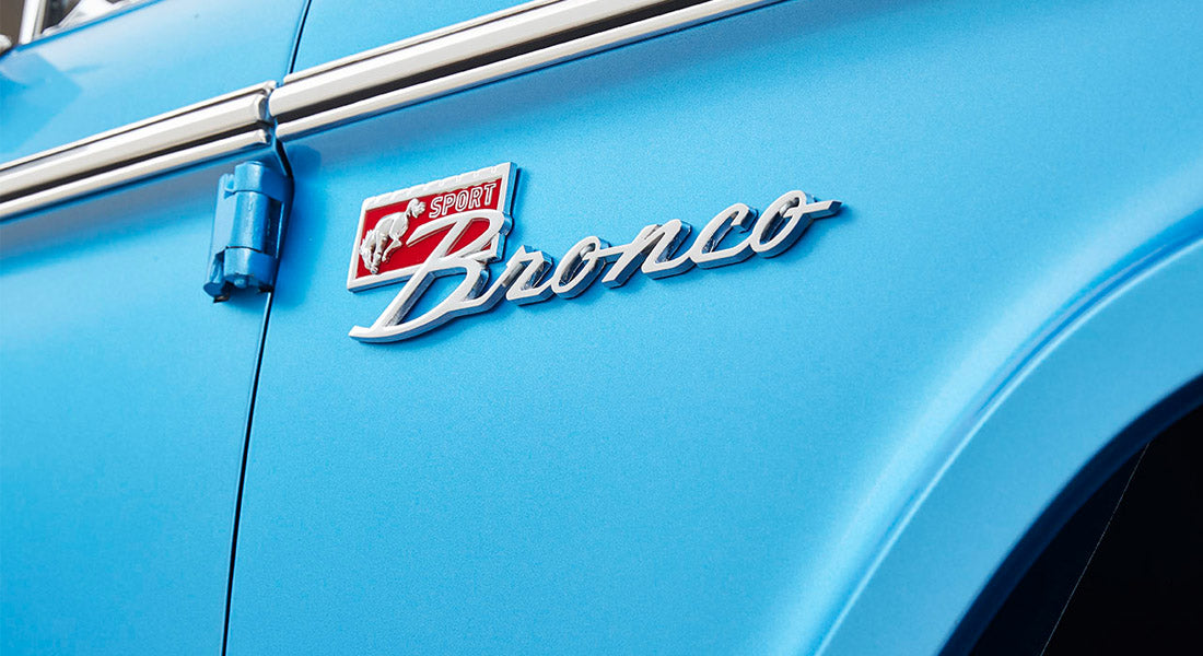 Close-up of blue Classic Ford Bronco door with sport Bronco emblem