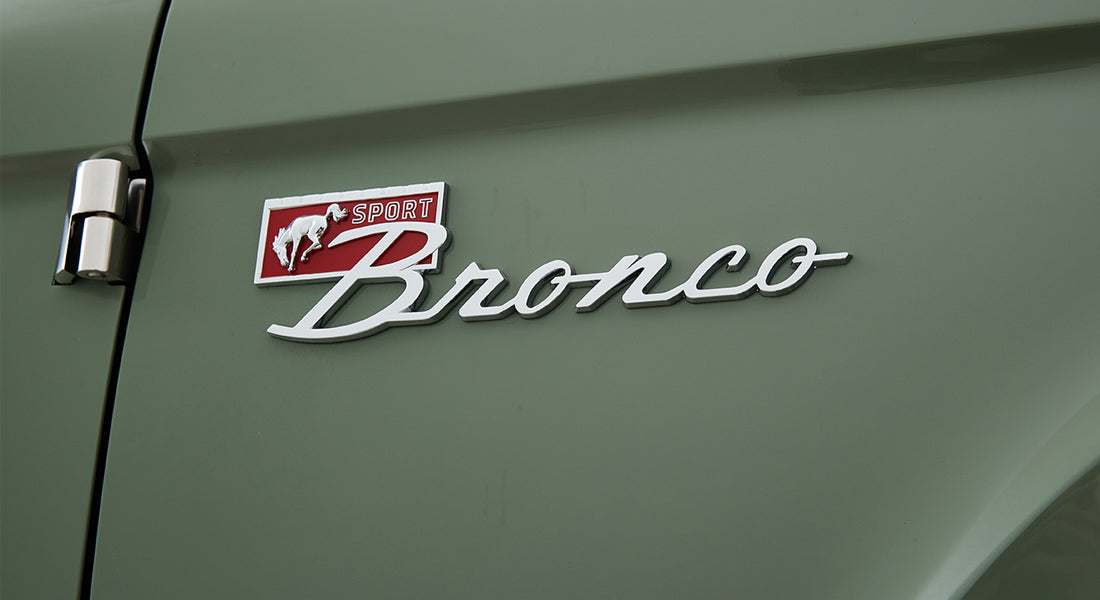 Green Classic Ford Bronco door featuring silver and red Sport Bronco emblem